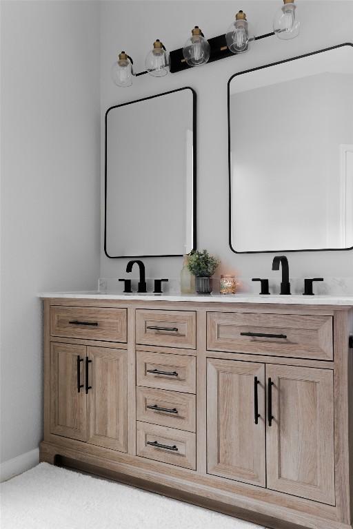 full bathroom featuring double vanity and a sink
