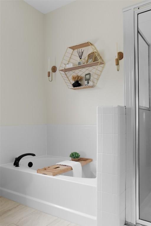 full bathroom featuring a garden tub and a stall shower