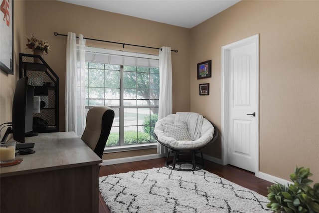 office area with dark wood finished floors and baseboards