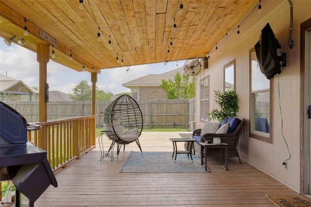deck with a fenced backyard and outdoor lounge area