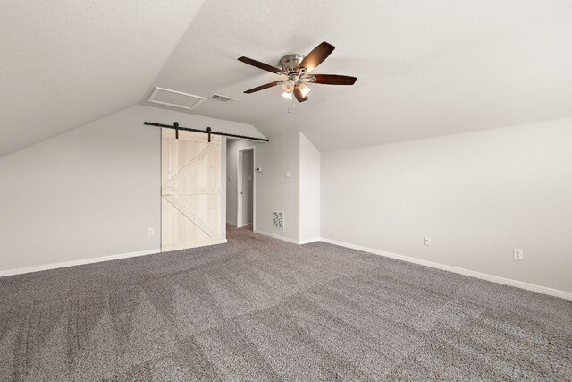 additional living space featuring lofted ceiling, visible vents, carpet floors, baseboards, and ceiling fan