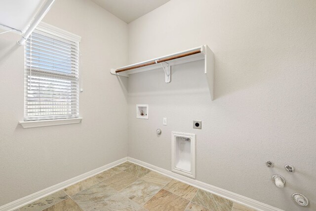 clothes washing area featuring hookup for a gas dryer, baseboards, laundry area, and hookup for a washing machine