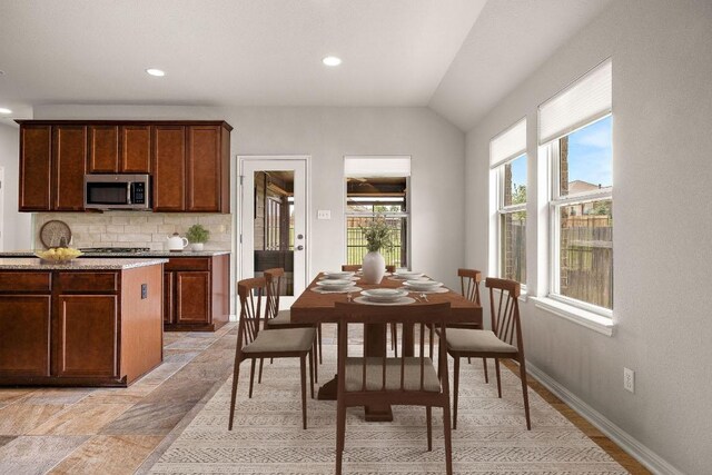 dining area with baseboards, recessed lighting, and lofted ceiling