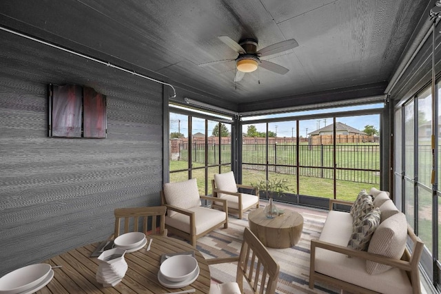 sunroom featuring an outdoor living space, a ceiling fan, and plenty of natural light