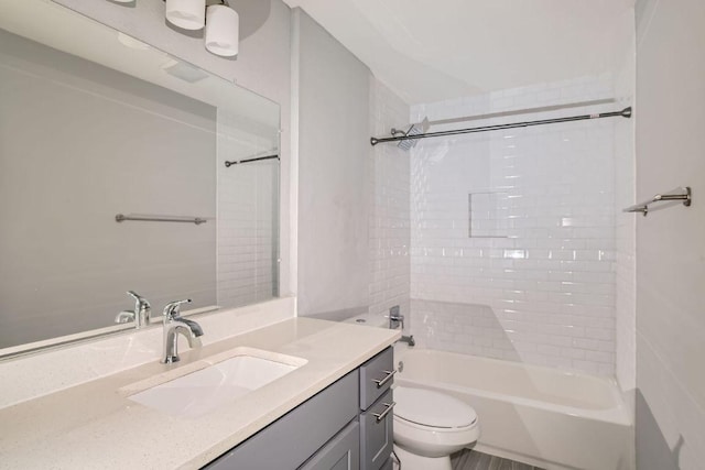 bathroom with shower / bath combination, toilet, and vanity