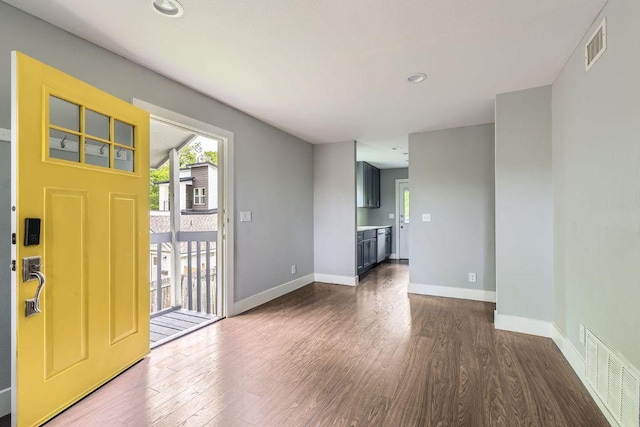 entryway featuring baseboards, dark wood-style flooring, and visible vents