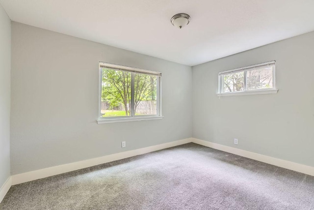 carpeted spare room with baseboards