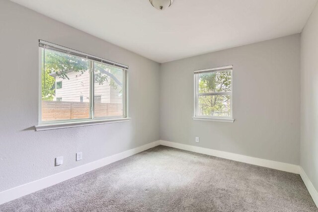 502 Capitol Dr, Austin, TX 78753 - carpeted empty room with baseboards