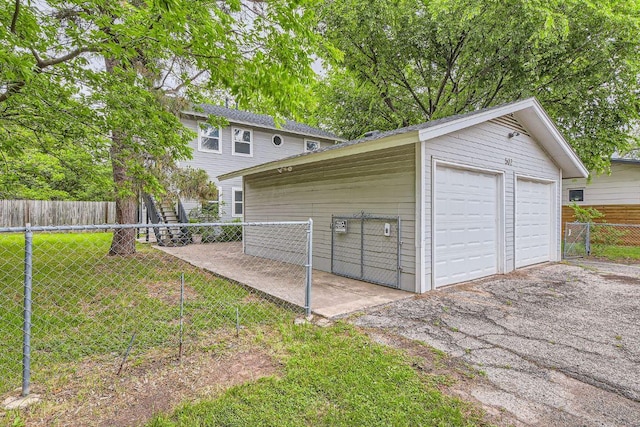 detached garage featuring fence
