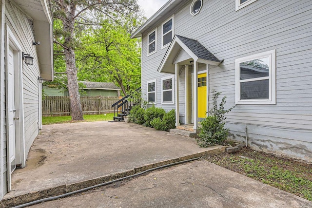 doorway to property featuring a patio area and fence