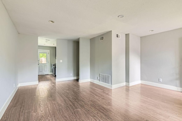 502 Capitol Dr, Austin, TX 78753 - empty room with wood finished floors and a textured ceiling