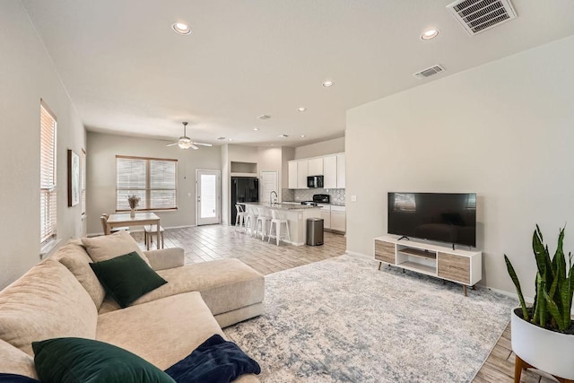 11509 Brindle Ct, Manor, TX 78653 - living room featuring a ceiling fan, recessed lighting, light wood-type flooring, and baseboards