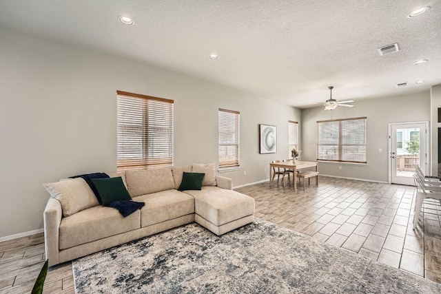 11509 Brindle Ct, Manor, TX 78653 - living room with light wood-style floors, baseboards, recessed lighting, ceiling fan, and a textured ceiling
