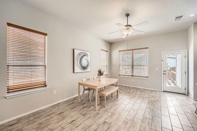 11509 Brindle Ct, Manor, TX 78653 - dining area with ceiling fan, light wood-style floors, and baseboards