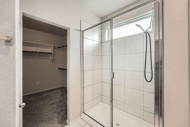 11509 Brindle Ct, Manor, TX 78653 - full bath featuring a shower stall, a walk in closet, and baseboards