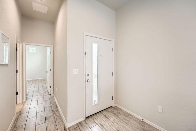 11509 Brindle Ct, Manor, TX 78653 - foyer entrance with baseboards, healthy amount of natural light, and light wood finished floors