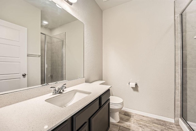 11509 Brindle Ct, Manor, TX 78653 - full bathroom with toilet, vanity, tiled shower, wood finished floors, and baseboards