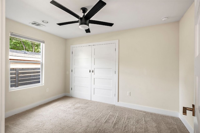 4709 Bandera Rd, Austin, TX 78721 - unfurnished bedroom with carpet flooring, a closet, and ceiling fan