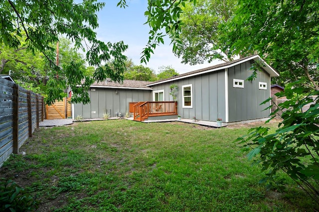 4709 Bandera Rd, Austin, TX 78721 - back of property featuring board and batten siding, a deck, and a fenced backyard