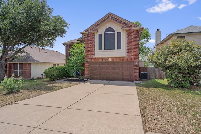 17320 Manish Dr, Pflugerville, TX 78660 - view of front of home with central AC, an attached garage, concrete driveway, and brick siding