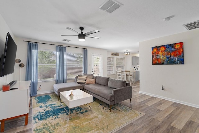 17320 Manish Dr, Pflugerville, TX 78660 - living area featuring a ceiling fan, wood finished floors, and baseboards