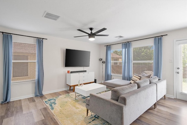 17320 Manish Dr, Pflugerville, TX 78660 - living room with light wood-type flooring, ceiling fan, and baseboards