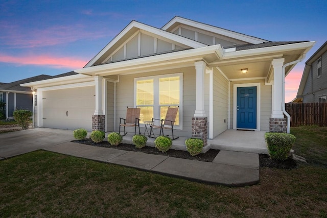 604 Nueces River Trl, Hutto, TX 78634 - view of front of house with covered porch, board and batten siding, an attached garage, concrete driveway, and stone siding