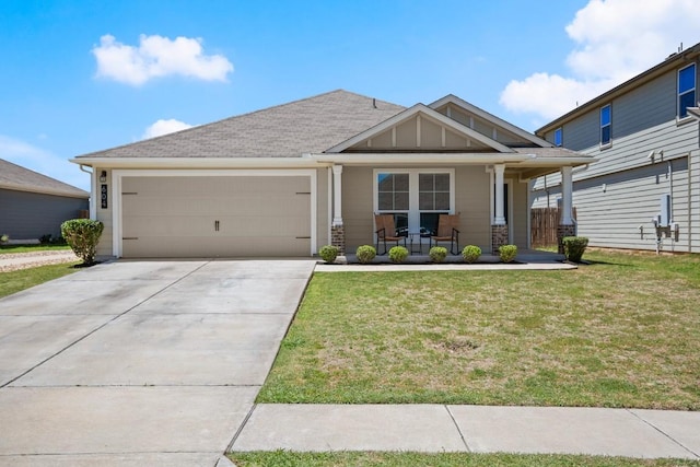604 Nueces River Trl, Hutto, TX 78634 - view of front of property with a porch, a garage, a front lawn, and concrete driveway