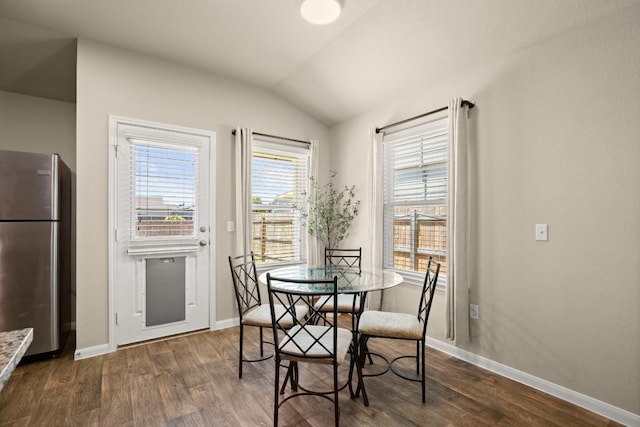 604 Nueces River Trl, Hutto, TX 78634 - dining room with dark wood-type flooring, vaulted ceiling, and baseboards