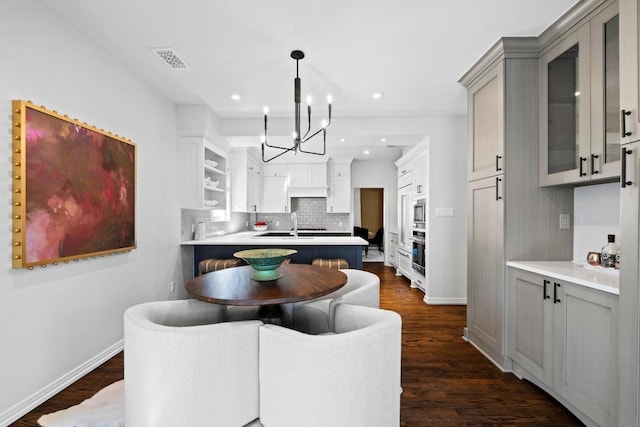 2702 Hillview Green Ln, Austin, TX 78703 - dining room featuring a chandelier, dark wood finished floors, and recessed lighting