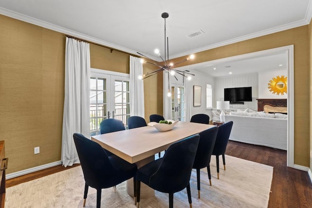 2702 Hillview Green Ln, Austin, TX 78703 - dining space with french doors, ornamental molding, wood finished floors, and a chandelier