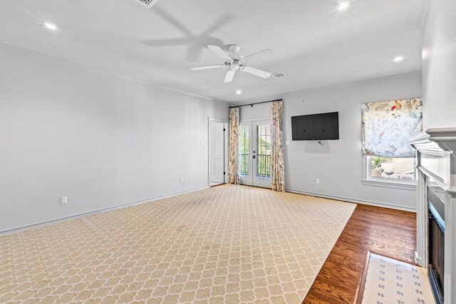 2702 Hillview Green Ln, Austin, TX 78703 - unfurnished living room featuring a fireplace with flush hearth, ornamental molding, ceiling fan, wood finished floors, and recessed lighting