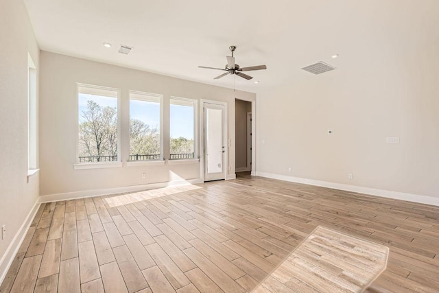 empty room with ceiling fan, visible vents, and light wood-style flooring