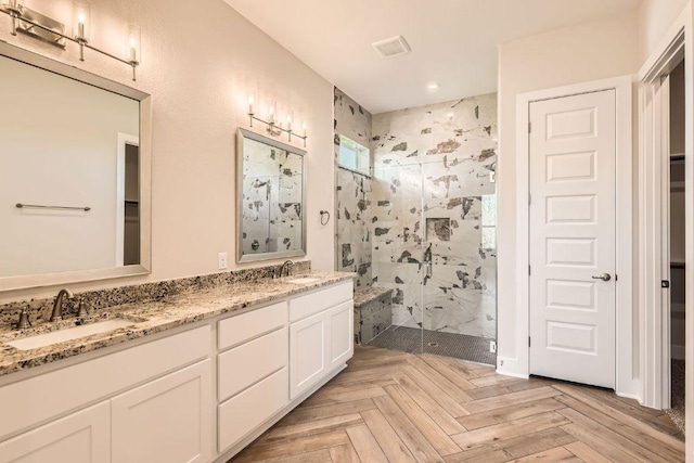 bathroom featuring a shower stall, a sink, visible vents, and recessed lighting