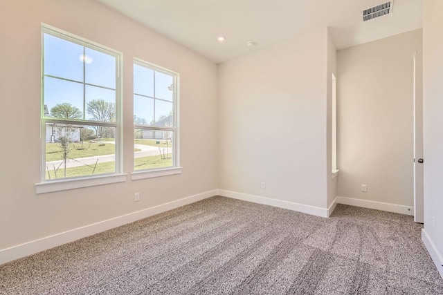 empty room with recessed lighting, carpet floors, visible vents, and baseboards