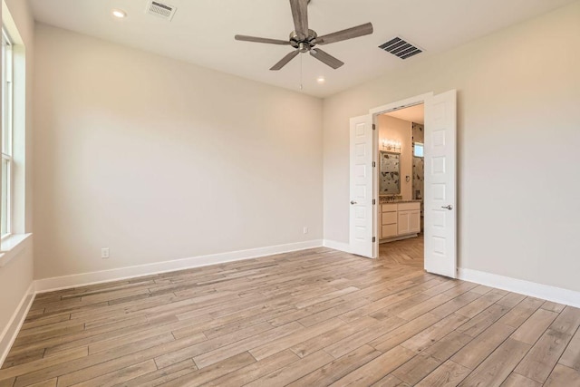 unfurnished bedroom featuring light wood-style floors, visible vents, and baseboards