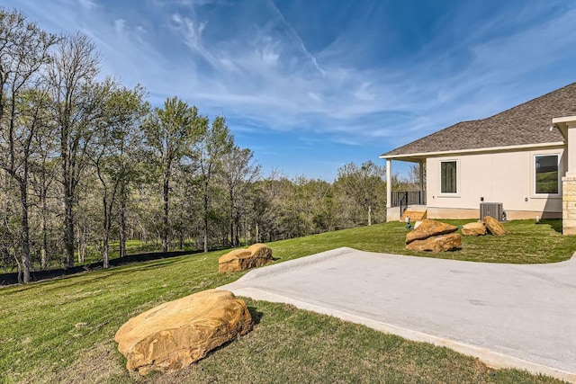 view of yard with a patio area and central AC unit