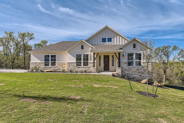 view of front facade with stone siding, a front lawn, and stucco siding