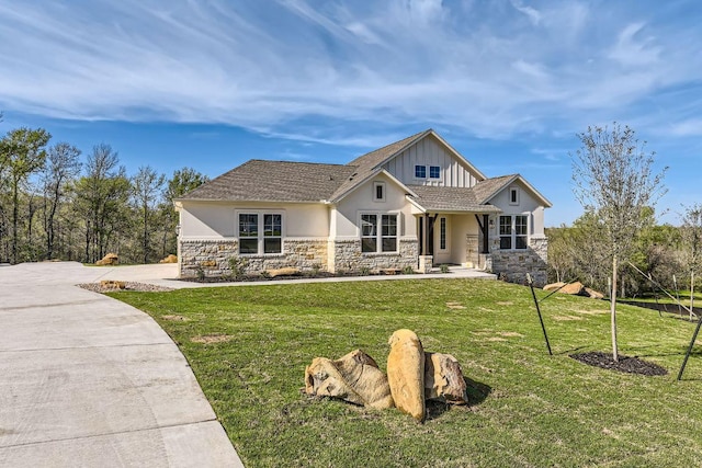 craftsman-style house featuring stone siding, a front lawn, board and batten siding, and stucco siding