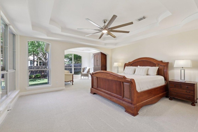 1900 Val Verde Dr, Austin, TX 78732 - bedroom with light carpet, visible vents, arched walkways, and a raised ceiling