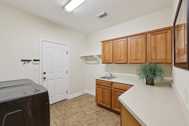 1900 Val Verde Dr, Austin, TX 78732 - clothes washing area with a sink, washing machine and dryer, baseboards, visible vents, and cabinet space