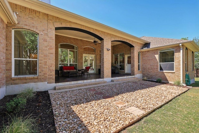 1900 Val Verde Dr, Austin, TX 78732 - back of property featuring brick siding, roof with shingles, and ceiling fan