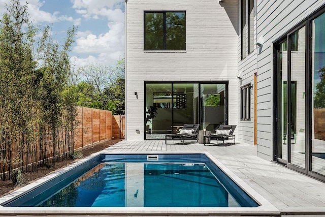 303 W Elizabeth St Unit A, Austin, TX 78704 - view of swimming pool featuring a deck, a fenced backyard, and an outdoor living space