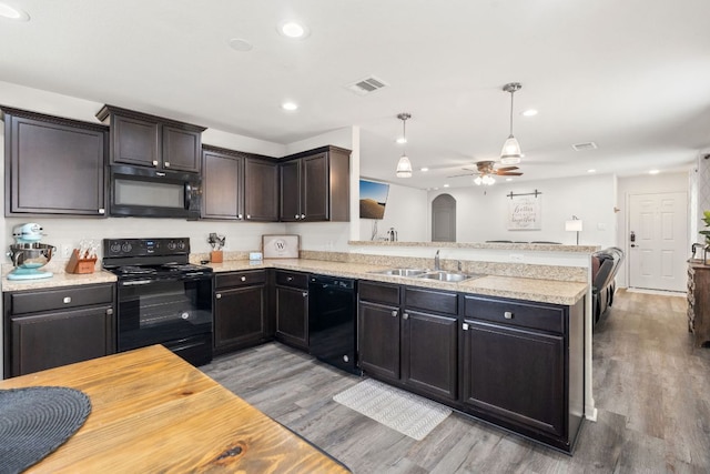 153 Proclamation Ave, Liberty Hill, TX 78642 - kitchen with light wood finished floors, a sink, visible vents, ceiling fan, and black appliances