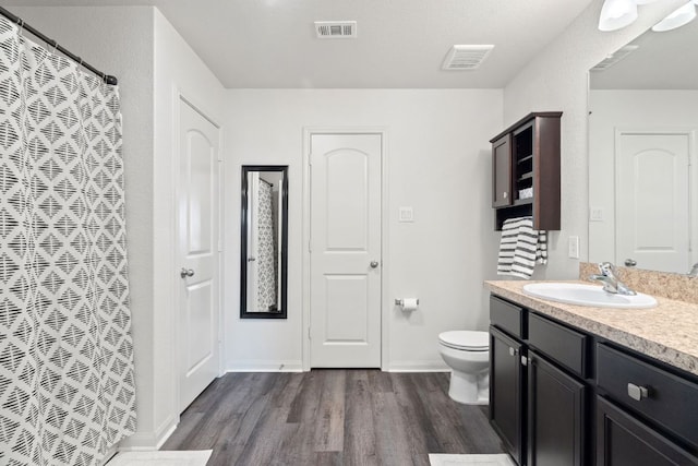 153 Proclamation Ave, Liberty Hill, TX 78642 - full bathroom featuring wood finished floors, visible vents, toilet, and vanity
