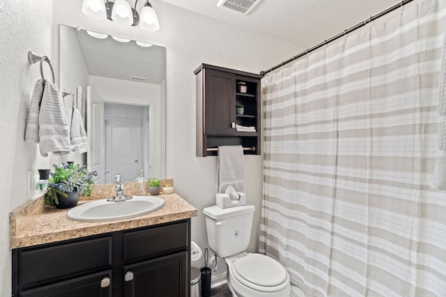 153 Proclamation Ave, Liberty Hill, TX 78642 - bathroom featuring vanity, curtained shower, a textured wall, toilet, and visible vents