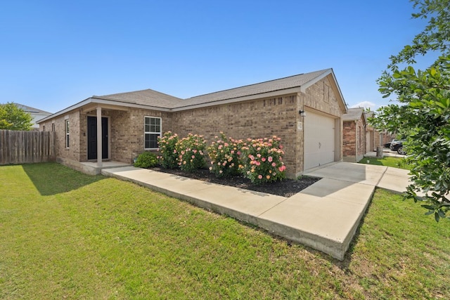 153 Proclamation Ave, Liberty Hill, TX 78642 - ranch-style home featuring driveway, fence, brick siding, a garage, and a front yard
