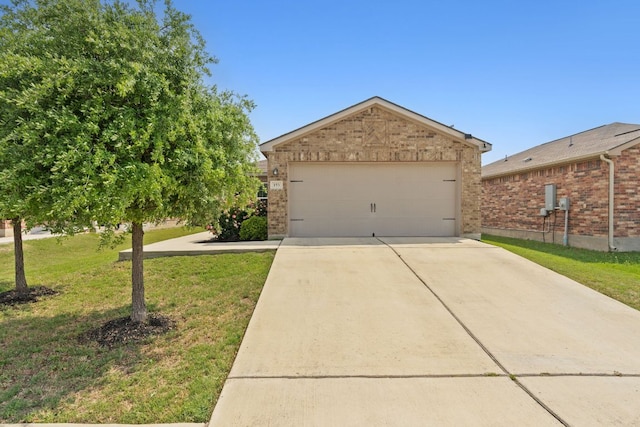 153 Proclamation Ave, Liberty Hill, TX 78642 - view of front of property with driveway, brick siding, a front yard, and a garage