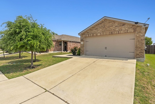 153 Proclamation Ave, Liberty Hill, TX 78642 - view of front of home featuring a garage, brick siding, a front lawn, and driveway