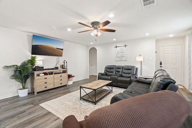 153 Proclamation Ave, Liberty Hill, TX 78642 - living area featuring arched walkways, visible vents, recessed lighting, a ceiling fan, and wood finished floors